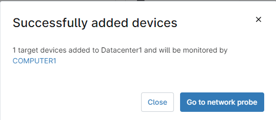 un avviso che indica che i dispositivi sono stati aggiunti con successo, insieme al nome del server di monitoraggio NMS.